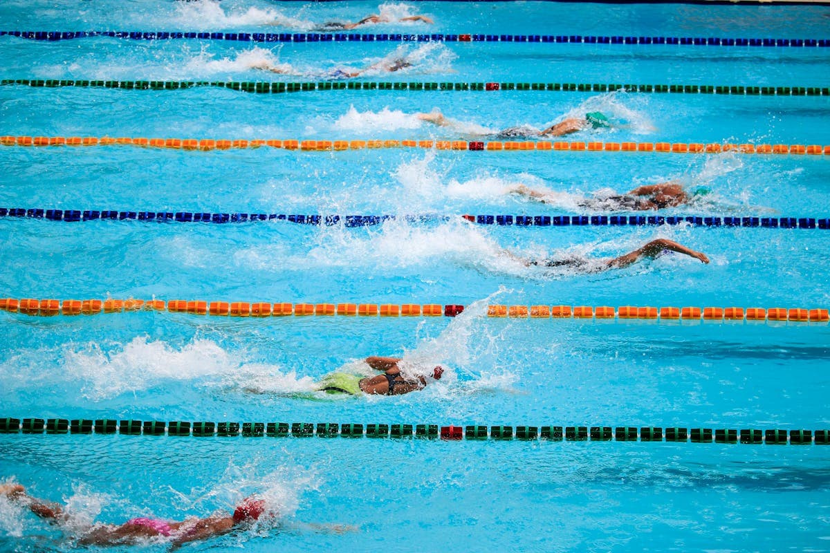 Swim instructor teaching student in pool